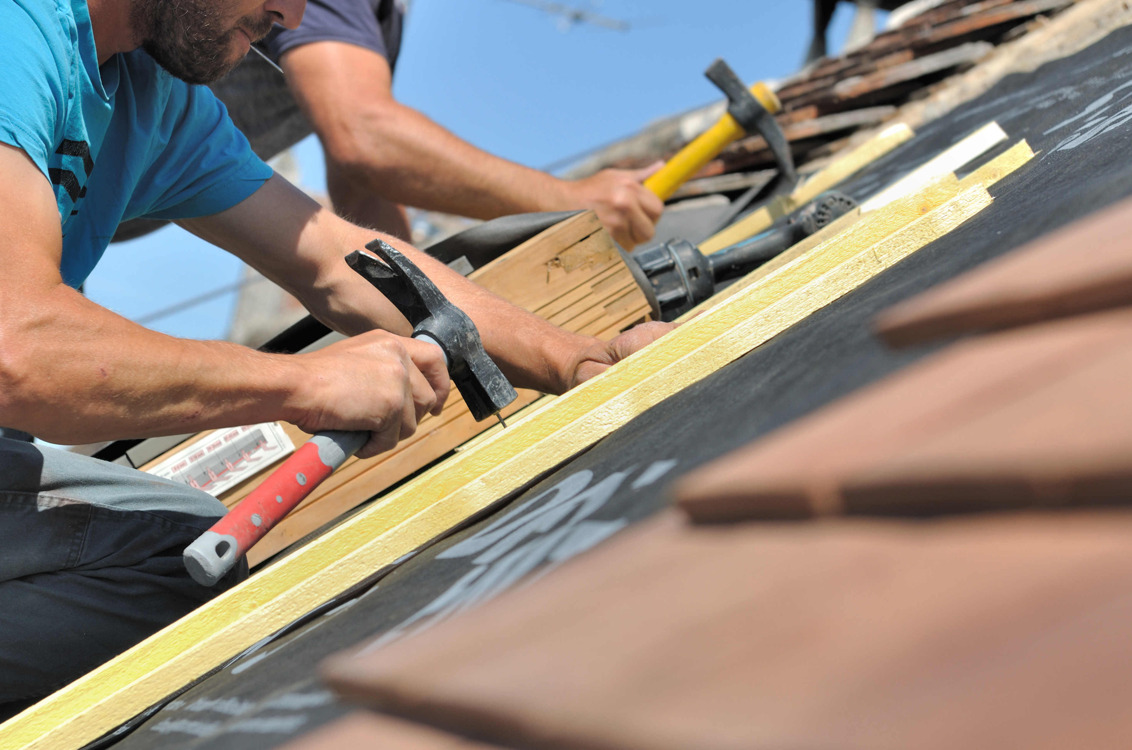 Two Roofers Repairing Roof